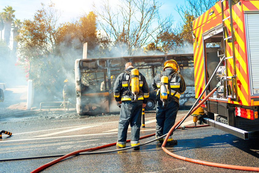 St. Louis Bus Accident Lawyers | Cantor Injury Law Rescue Team of Firefighters Arrive on the Car Crash fired passenger bus Traffic Accident Scene. Firemen fire department fight with fire on road.
