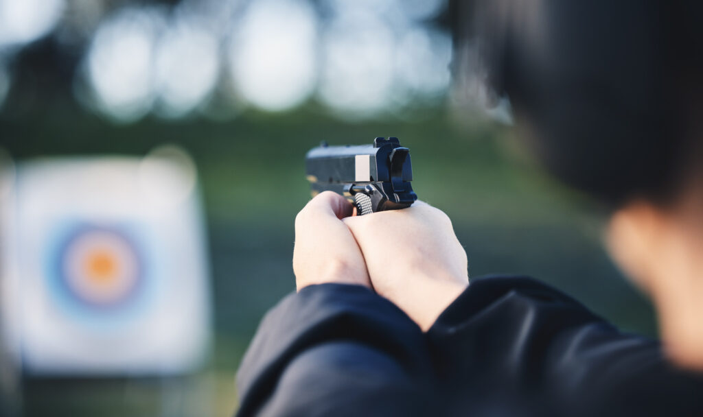 Firing a gun at the firing range.