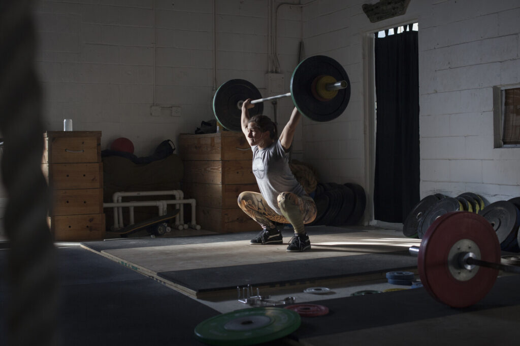 Woman deadlifting weights.