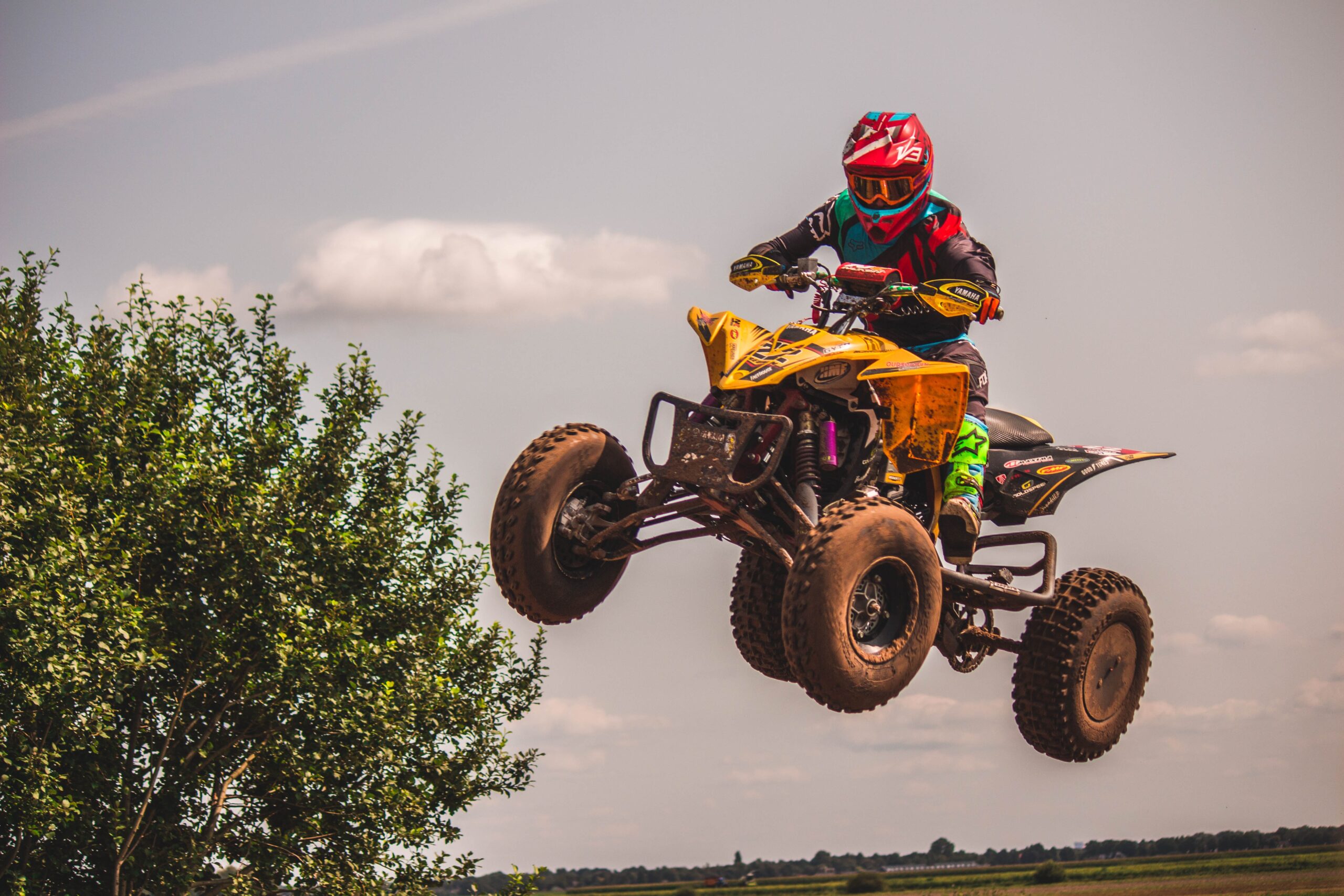 A man riding an atv off a ramp