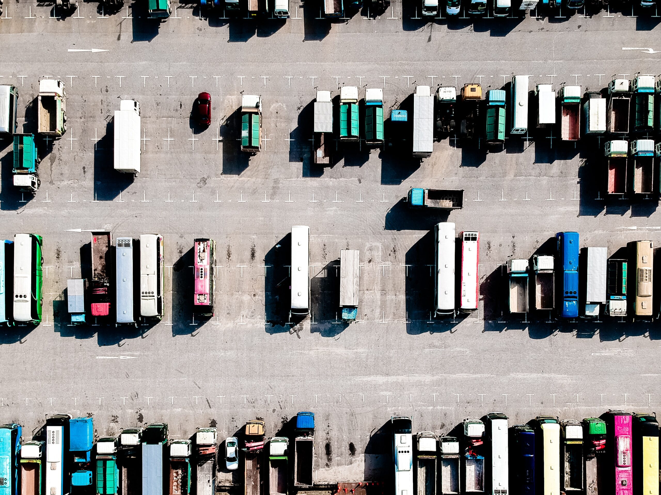 A parking lot full of commercial vehicles and trucks