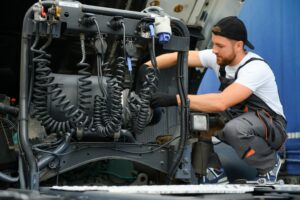 Mechanic Workin On A Truck | Cantor Injury Law Mechanic working on a truck.