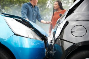 Two Angry Motorists Arguing Over Uninsured Vs. Underinsured Motorist Coverage.